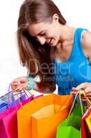 attractive young woman with colorful shopping bags isolated