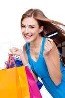 attractive young woman with colorful shopping bags isolated