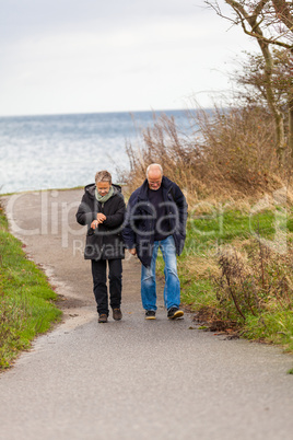 happy mature couple relaxing baltic sea dunes