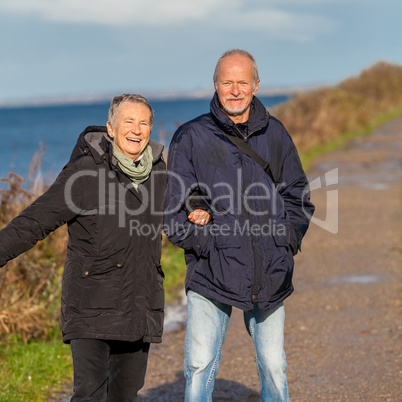 happy mature couple relaxing baltic sea dunes