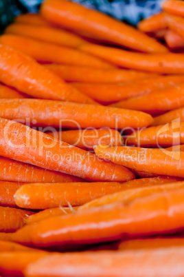 fresh orange carrots on market in summer