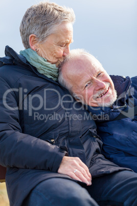 happy senior couple relaxing together in the sunshine