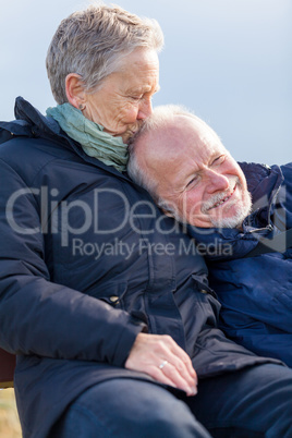 happy senior couple relaxing together in the sunshine