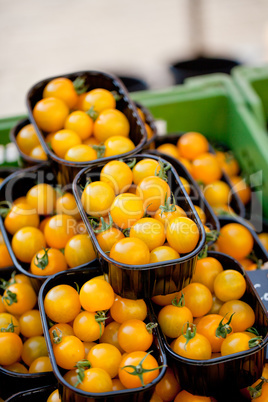 fresh tasty yellow cherry tomatoes macro closeup on market