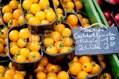 fresh tasty yellow cherry tomatoes macro closeup on market