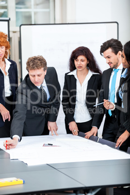 business people discussing architecture plan sketch