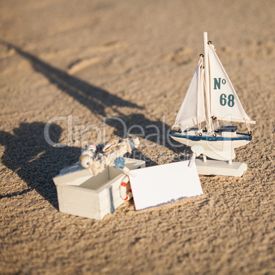 sailing boat and seashell in sand decoration closeup