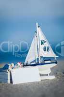 sailing boat and seashell in sand decoration closeup