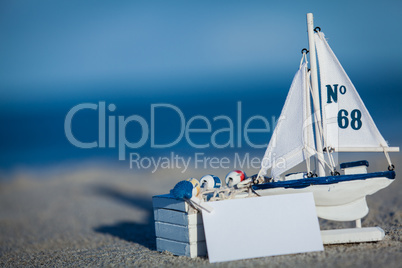 sailing boat and seashell in sand decoration closeup