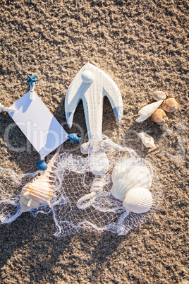 sailing boat and seashell in sand decoration closeup