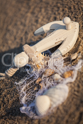 sailing boat and seashell in sand decoration closeup