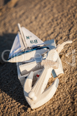 sailing boat and seashell in sand decoration closeup