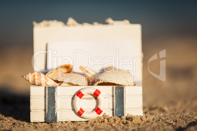 sailing boat and seashell in sand decoration closeup