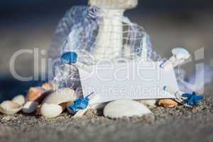 sailing boat and seashell in sand decoration closeup