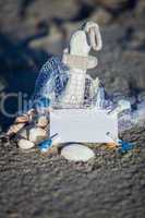 sailing boat and seashell in sand decoration closeup