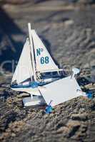 sailing boat and seashell in sand decoration closeup