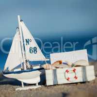 sailing boat and seashell in sand decoration closeup