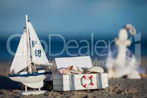 sailing boat and seashell in sand decoration closeup