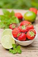 fresh tasty sweet strawberries and green lime outdoor in summer