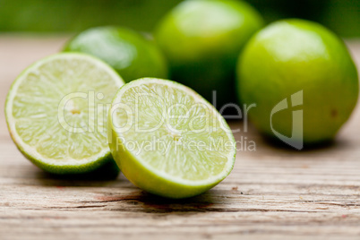 green fresh lime on wooden table macro closeup outdoor