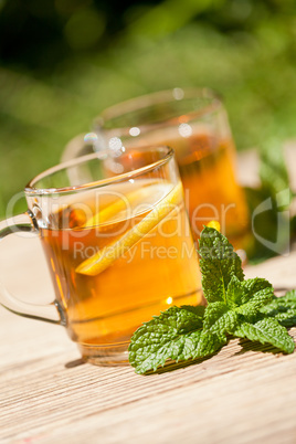 fresh tasty hot tea lemon and mint outdoor in summer