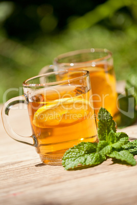 fresh tasty hot tea lemon and mint outdoor in summer