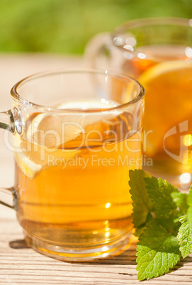 fresh tasty hot tea lemon and mint outdoor in summer