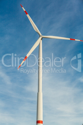 Wind turbine against a blue hazy sky