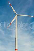 Wind turbine against a blue hazy sky