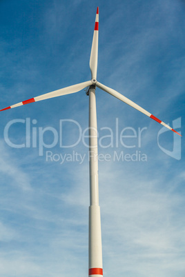 Wind turbine against a blue hazy sky