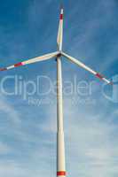 Wind turbine against a blue hazy sky