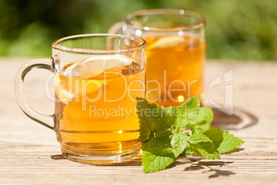 fresh tasty hot tea lemon and mint outdoor in summer