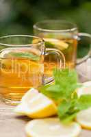 fresh tasty hot tea lemon and mint outdoor in summer