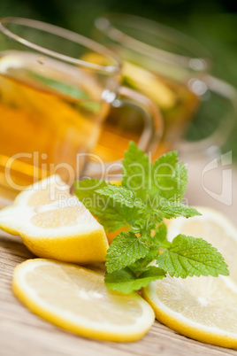 fresh tasty hot tea lemon and mint outdoor in summer