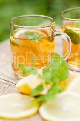 fresh tasty hot tea lemon and mint outdoor in summer