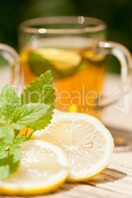 fresh tasty hot tea lemon and mint outdoor in summer