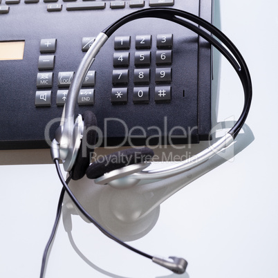 office desk with telephone and headset objects