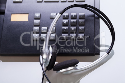 office desk with telephone and headset objects