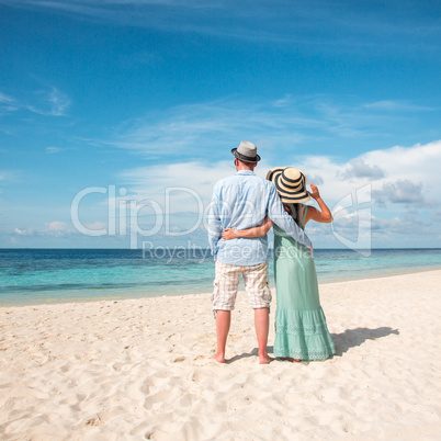 Vacation Couple walking on tropical beach Maldives.