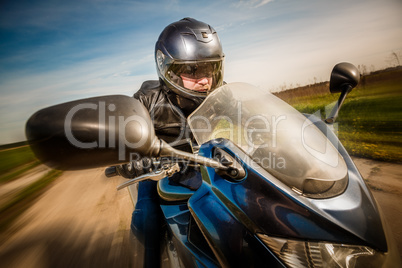 Biker racing on the road Biker racing on the road