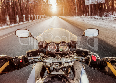 Biker First-person view. Winter slippery road