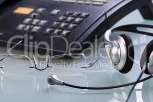 working place office desk table headset glasses telephone