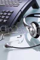 working place office desk table headset glasses telephone