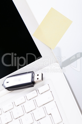 notebook laptop with post it memo and usb stick
