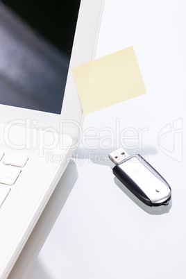 notebook laptop with post it memo and usb stick