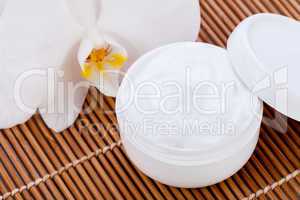 cosmetic face cream on wooden background