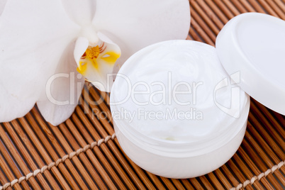 cosmetic face cream on wooden background