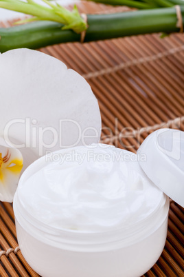 cosmetic face cream on wooden background