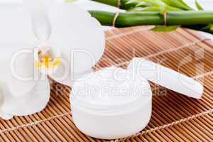 cosmetic face cream on wooden background