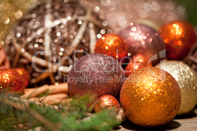 glittering christmas decoration in orange and brown natural wood